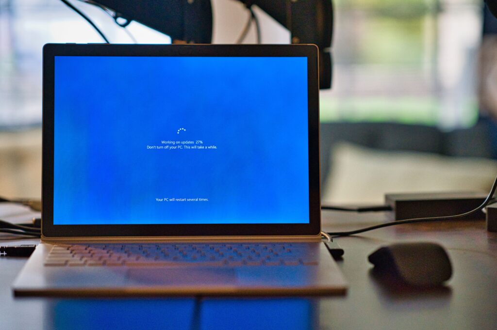 An image of a laptop showing an ongoing Windows update screen