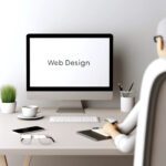 A simple and clean web design workspace with minimalistic style featuring a single designer working on a sleek modern computer.