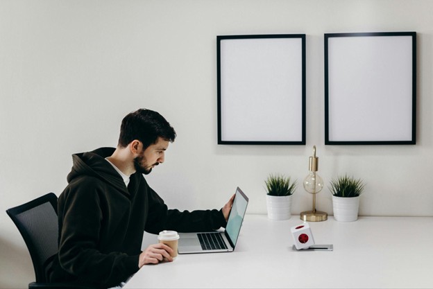 A tech startup entrepreneur seating in front of a laptop